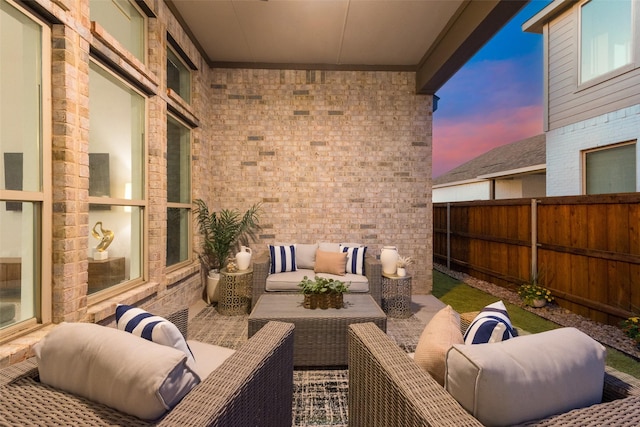 patio terrace at dusk with fence and an outdoor hangout area