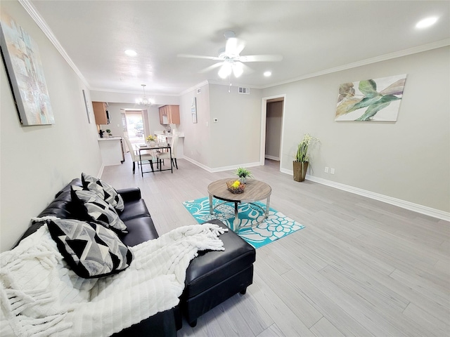 living area featuring light wood-style floors, visible vents, recessed lighting, ornamental molding, and ceiling fan with notable chandelier