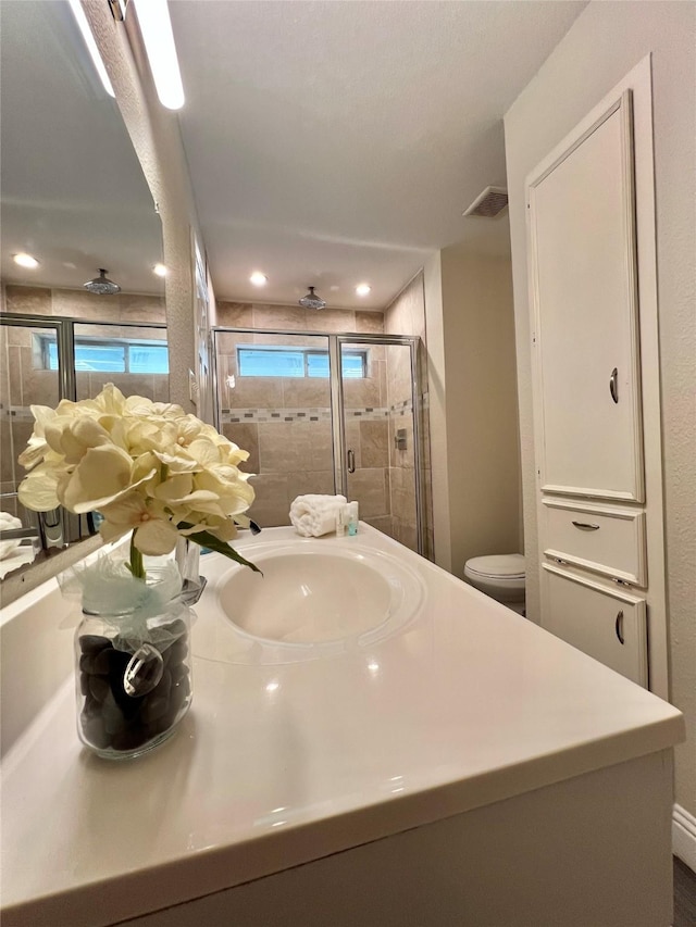 bathroom with visible vents, recessed lighting, a stall shower, and vanity