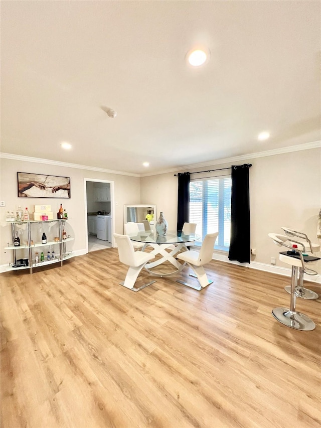 exercise area featuring baseboards, wood finished floors, and crown molding