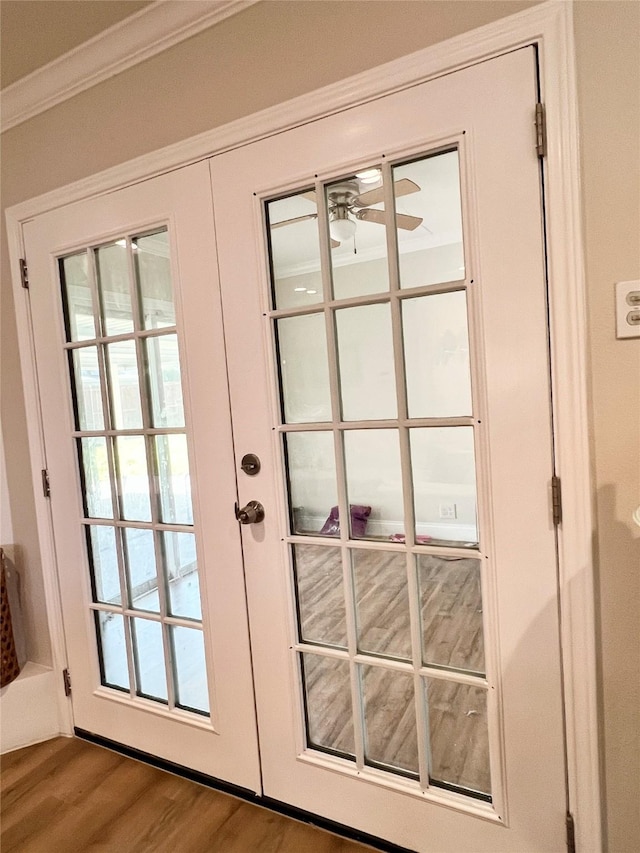 doorway with ceiling fan, french doors, wood finished floors, and crown molding