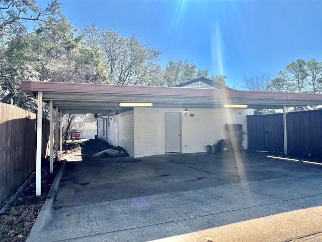 view of car parking featuring driveway and fence