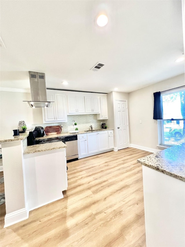 kitchen with visible vents, light wood-style flooring, island range hood, white cabinetry, and stainless steel dishwasher