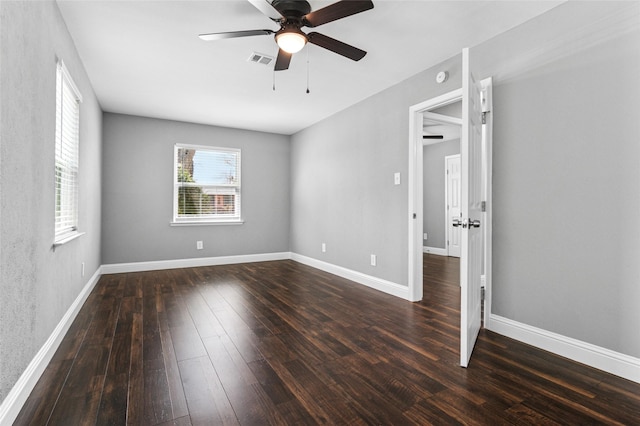 empty room with visible vents, baseboards, a ceiling fan, and wood-type flooring