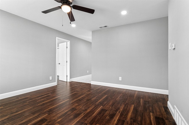 unfurnished room with ceiling fan, visible vents, baseboards, and wood finished floors