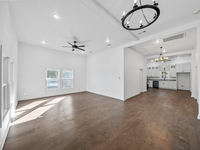 unfurnished living room with visible vents, dark wood-type flooring, ceiling fan with notable chandelier, recessed lighting, and baseboards