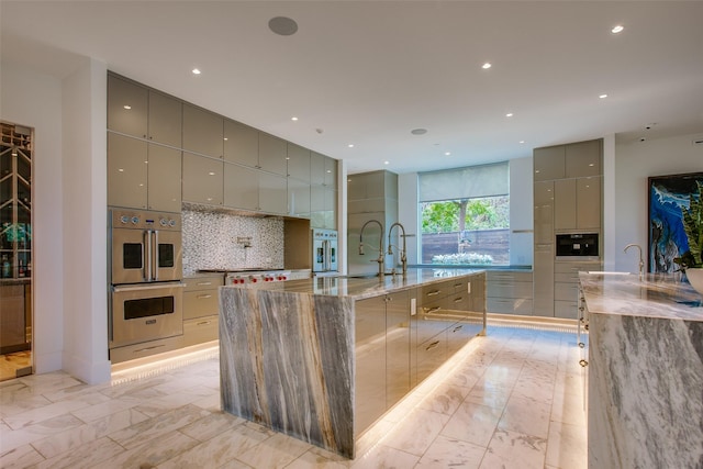 kitchen with marble finish floor, gray cabinetry, modern cabinets, and stainless steel appliances