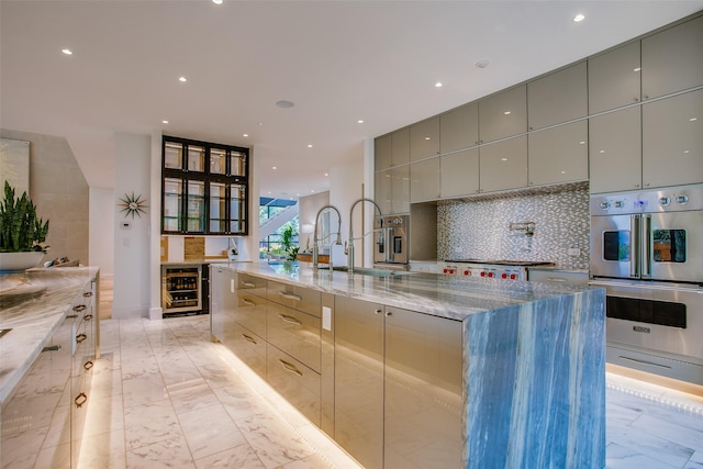 kitchen featuring modern cabinets, wine cooler, marble finish floor, and gray cabinetry