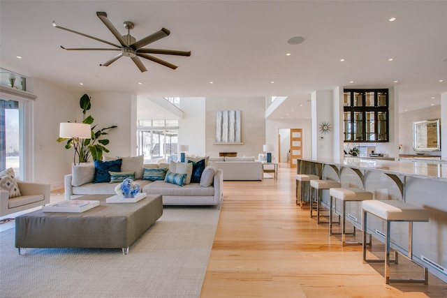 living area featuring recessed lighting, plenty of natural light, and light wood-style floors