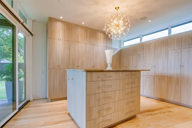 walk in closet featuring an inviting chandelier and light wood-style flooring