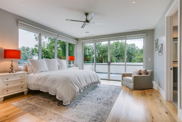 bedroom featuring access to exterior, light wood-style floors, baseboards, and ceiling fan