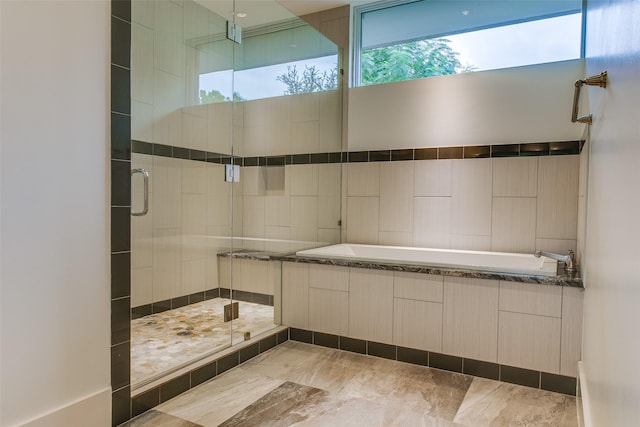 bathroom with a shower stall and a garden tub