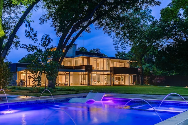 view of swimming pool with a lawn