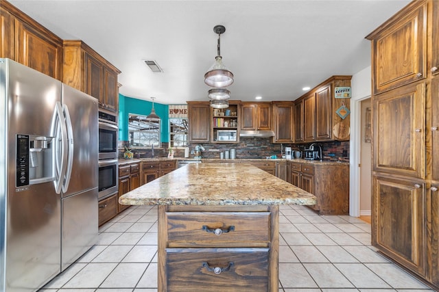 kitchen with visible vents, under cabinet range hood, tasteful backsplash, stainless steel appliances, and light tile patterned flooring