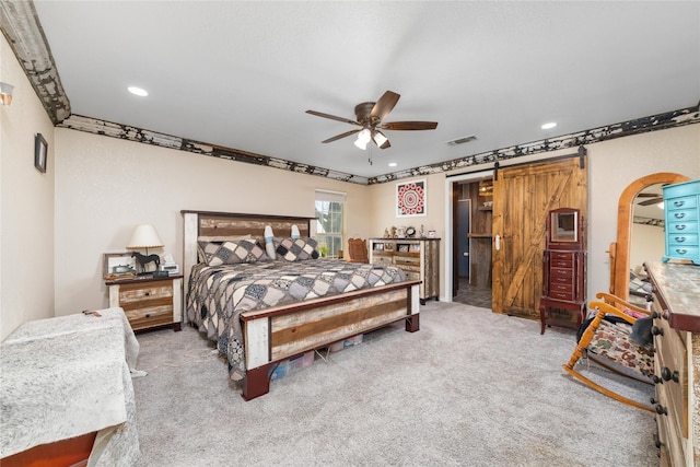 carpeted bedroom with visible vents, ceiling fan, a barn door, recessed lighting, and arched walkways