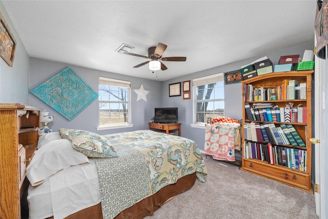 bedroom featuring visible vents, carpet floors, and ceiling fan