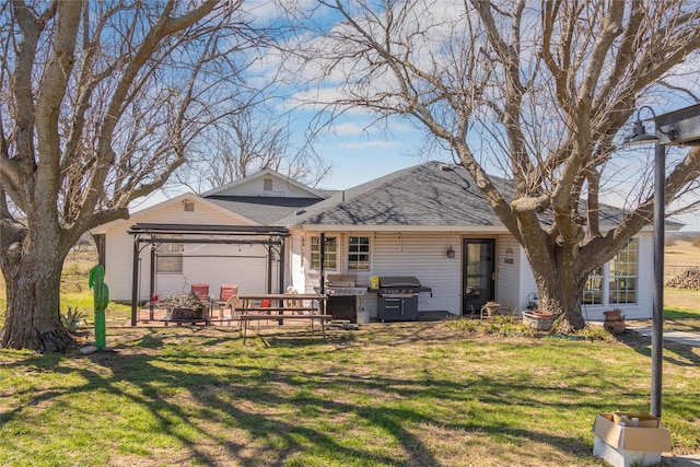 exterior space featuring a gazebo, a front yard, and a shingled roof