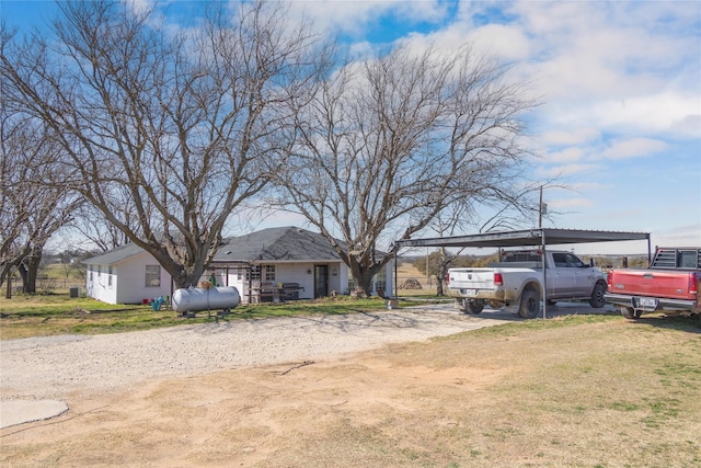 view of yard with dirt driveway