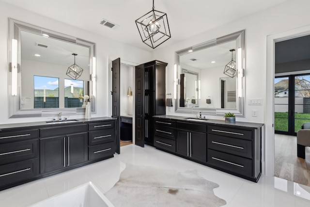 full bathroom with two vanities, visible vents, and a sink