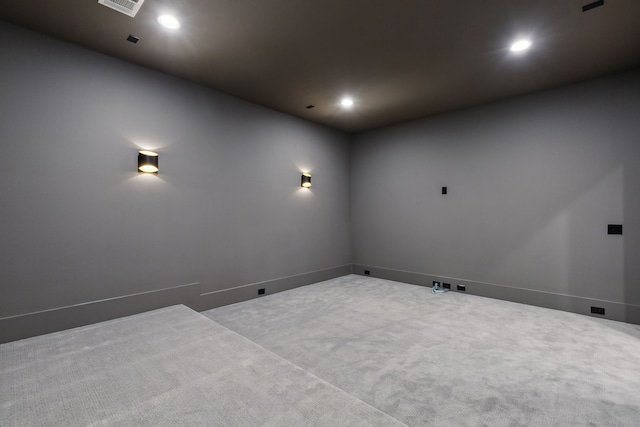 empty room with recessed lighting, visible vents, and carpet