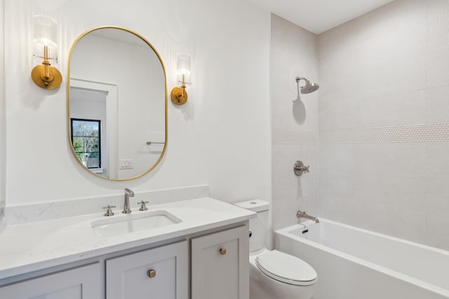 bathroom with toilet, vanity, and  shower combination