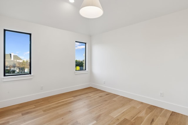 unfurnished room with light wood-style floors and baseboards