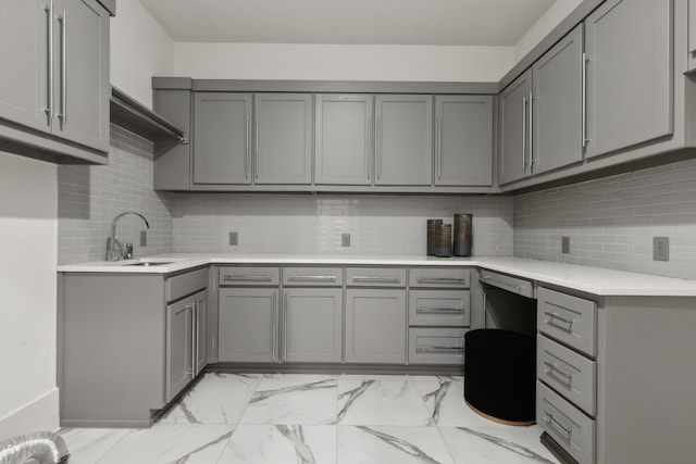 kitchen featuring gray cabinets and a sink