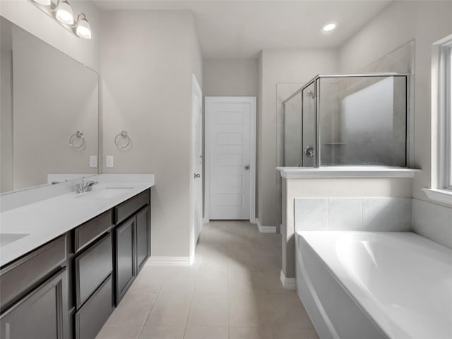 full bathroom featuring a shower stall, a garden tub, double vanity, tile patterned floors, and a sink