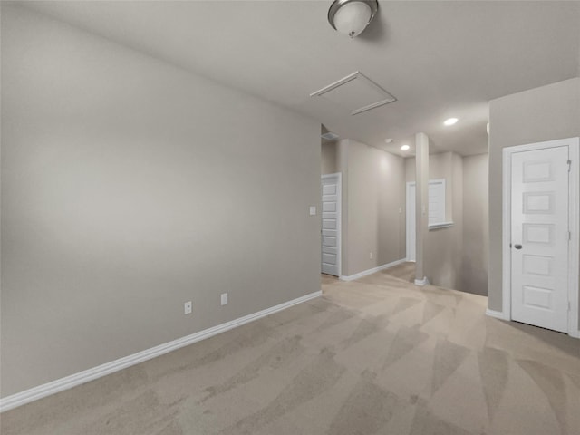 empty room featuring attic access, recessed lighting, light colored carpet, and baseboards