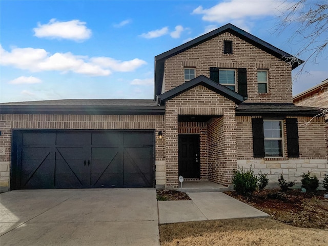 traditional-style home with driveway, brick siding, a garage, and stone siding