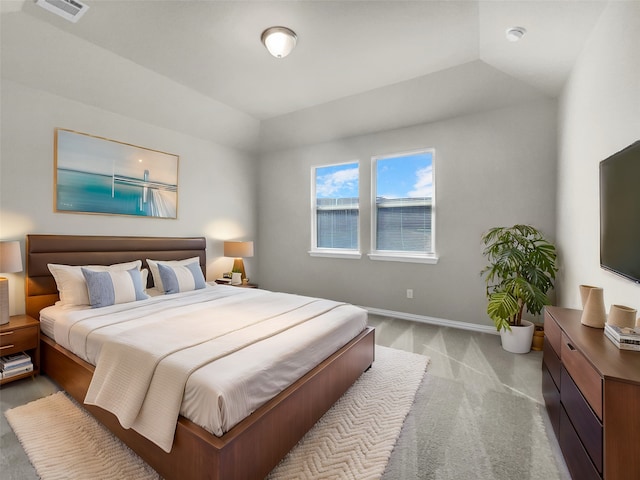 bedroom with lofted ceiling, baseboards, visible vents, and carpet floors