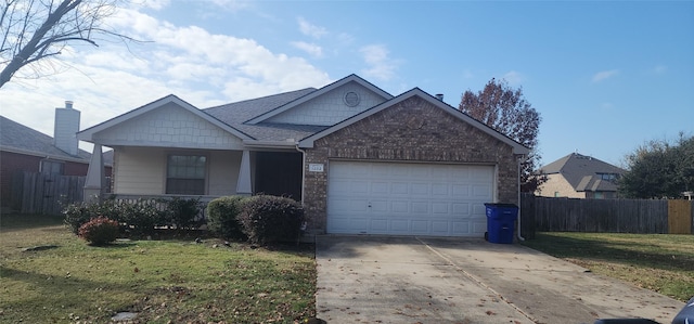 view of front of property featuring a front lawn, fence, a porch, driveway, and an attached garage