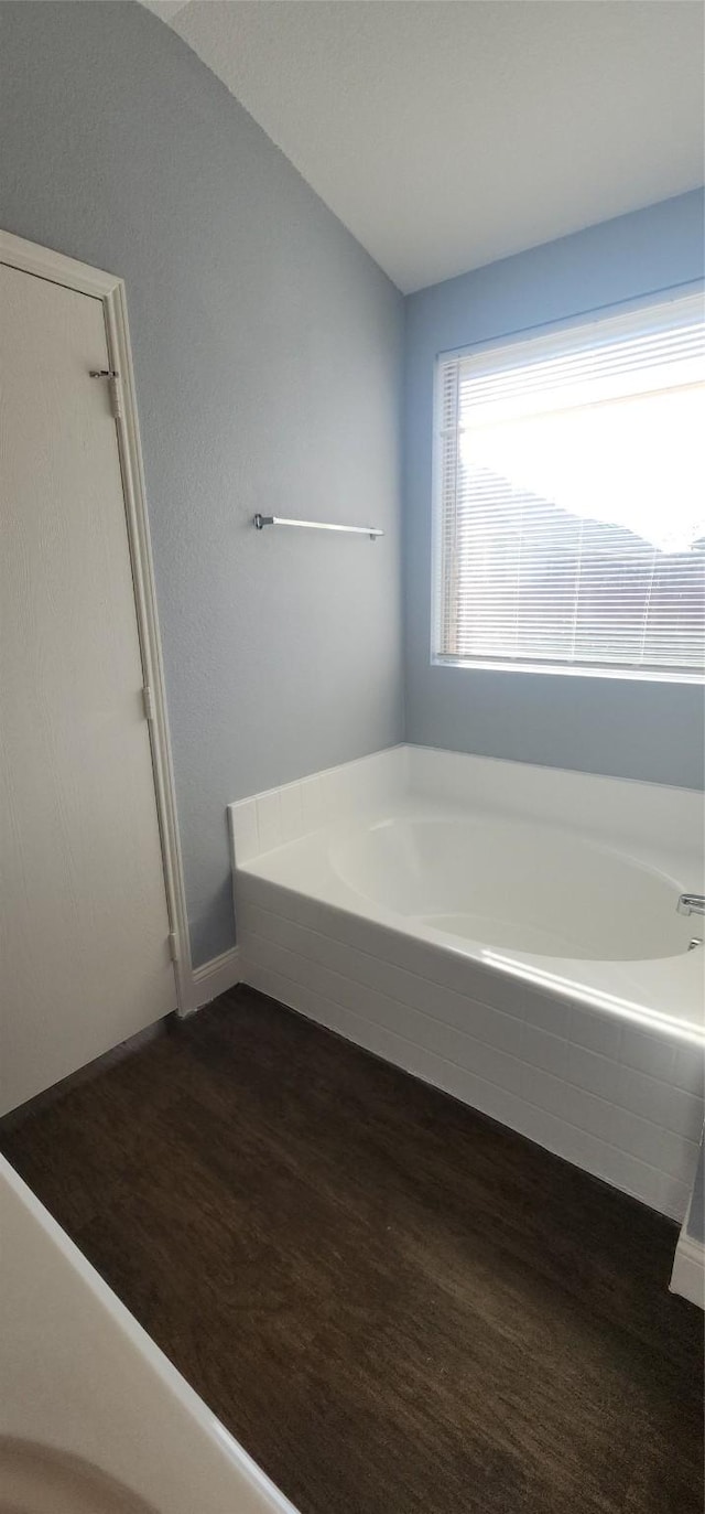 full bathroom with a garden tub and wood finished floors