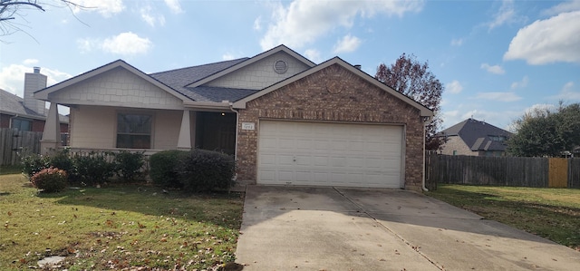 view of front of property featuring a garage, driveway, a front lawn, and fence