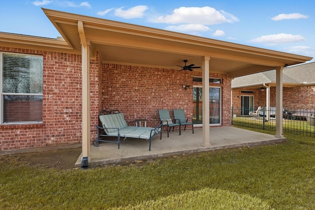 view of patio featuring a ceiling fan and fence