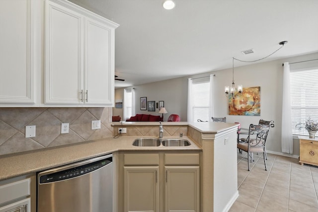 kitchen with visible vents, light tile patterned floors, a peninsula, stainless steel dishwasher, and a sink