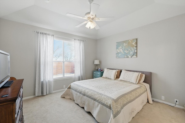 bedroom with light colored carpet, baseboards, and ceiling fan