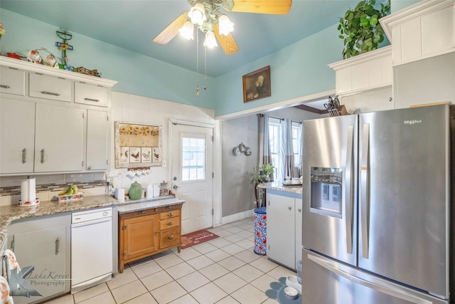 kitchen featuring light tile patterned floors, stainless steel fridge, and ceiling fan