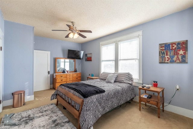 bedroom featuring carpet flooring, a ceiling fan, baseboards, and a textured ceiling