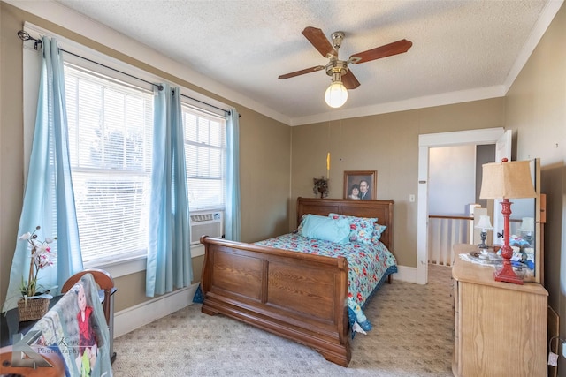 bedroom featuring a textured ceiling, crown molding, ceiling fan, and light carpet