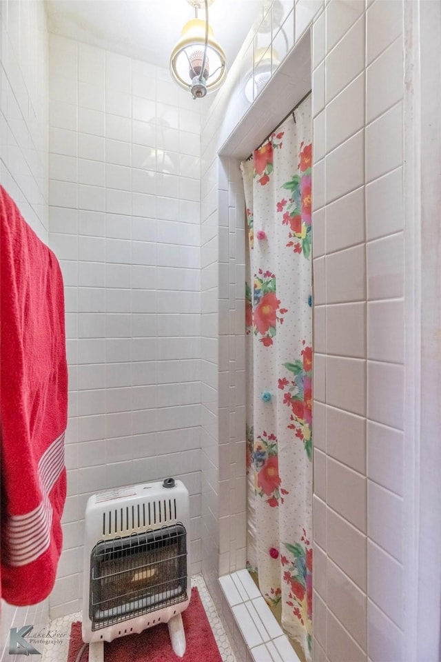 full bath with tiled shower and heating unit