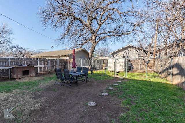 view of yard featuring a fenced backyard and a gate