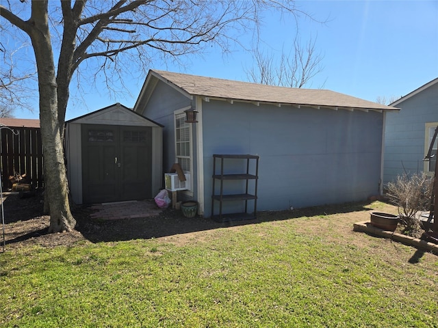 view of shed featuring fence