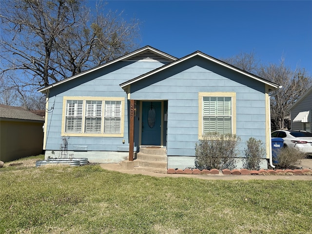 bungalow-style house with a front lawn