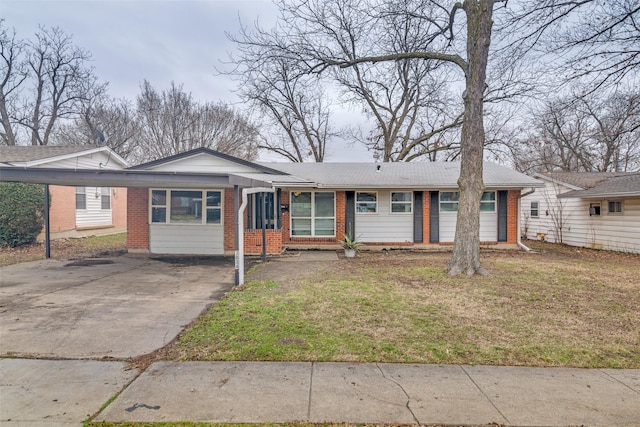 single story home with a front lawn, brick siding, and driveway