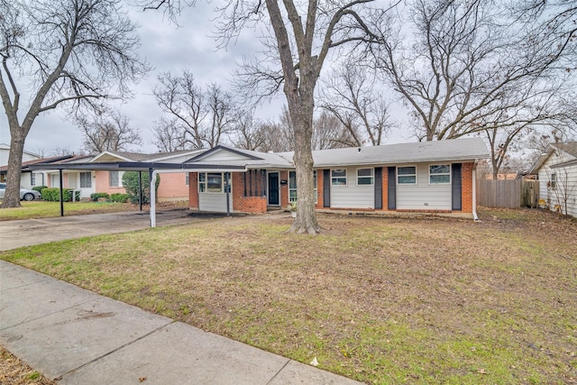 ranch-style home with a front lawn, brick siding, driveway, and fence