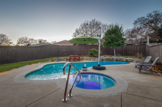 view of swimming pool with a patio area, a fenced in pool, a hot tub, and a fenced backyard