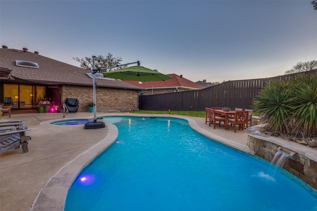 view of swimming pool with an in ground hot tub, fence, a fenced in pool, and a patio