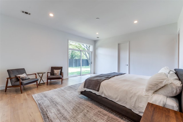 bedroom featuring recessed lighting, visible vents, light wood-style floors, and access to outside