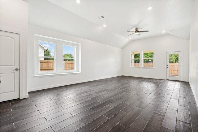 interior space featuring baseboards, lofted ceiling, and wood finish floors